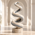 THE ENDLESS SPIRAL – A Sculpture for Time Beyond Time. Not a beginning. Not an end. Only the flow. Three-quarter angled overhead view in warm cream arched gallery interior with potted olive branch visible in soft-focus background